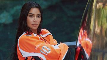 Kim Kardashian was photographed by Greg Swales in the Dominican Republic. Swimsuit by SKIMS. Top by Balenciaga. Gloves by Fox. 