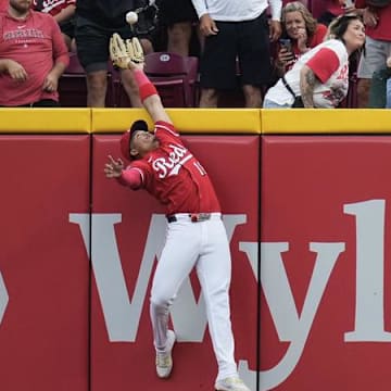 Cincinnati Reds outfielder Noelvi Marte jumps at the wall to rob a Pittsburgh Pirates home run in the ninth inning.
