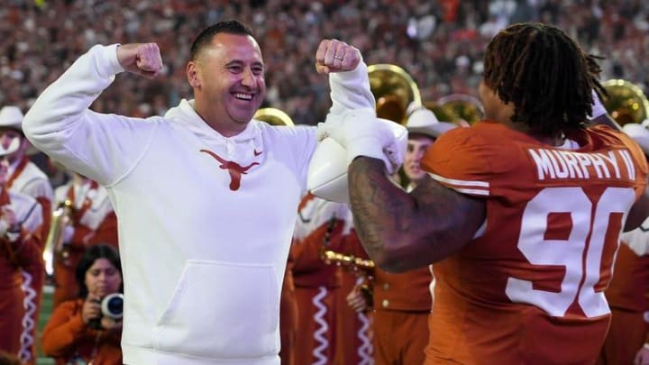 Texas Longhorns head coach Steve Sarkisian greets Texas Longhorns defensive lineman Byron Murphy II (90) on senior night before the game against Texas Tech at Darrell K Royal Texas Memorial Stadium on Friday, Nov. 24, 2023.