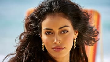 Cindy Kimberly was photographed by Ben Watts in Barbados. Swimsuit by Andi Bagus. Earrings by En Route Jewelry.