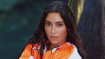 Kim Kardashian was photographed by Greg Swales in the Dominican Republic. Swimsuit by SKIMS. Top by Balenciaga. Gloves by Fox. 