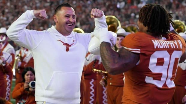 Steve Sarkisian celebrates with players before the 2023 contest against Texas Tech