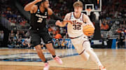 Illinois guard Kasparas Jakucionis (32) drives to the basket against Xavier forward Jerome Hunter (2) in an NCAA Tournament game at Fiserv Forum in Milwaukee, Wisconsin on Friday, March 21, 2025.