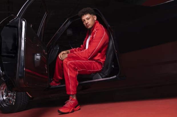 Patrick Mahomes models red adidas apparel.