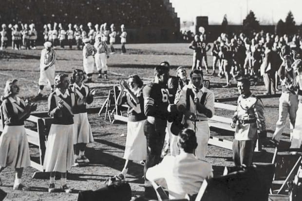 Tom “Train Wreck” Novak says a few words after being serenaded by the crowd and the University of Nebraska marching band.