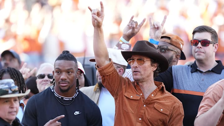 Nov 23, 2024; Austin, Texas, USA; Former Texas Longhorn and Atlanta Falcons running back Bijan Robinson and actor Matthew McConaughey hold up their horns before a game against the Kentucky Wildcats at Darrell K Royal-Texas Memorial Stadium. Mandatory Credit: Scott Wachter-Imagn Images