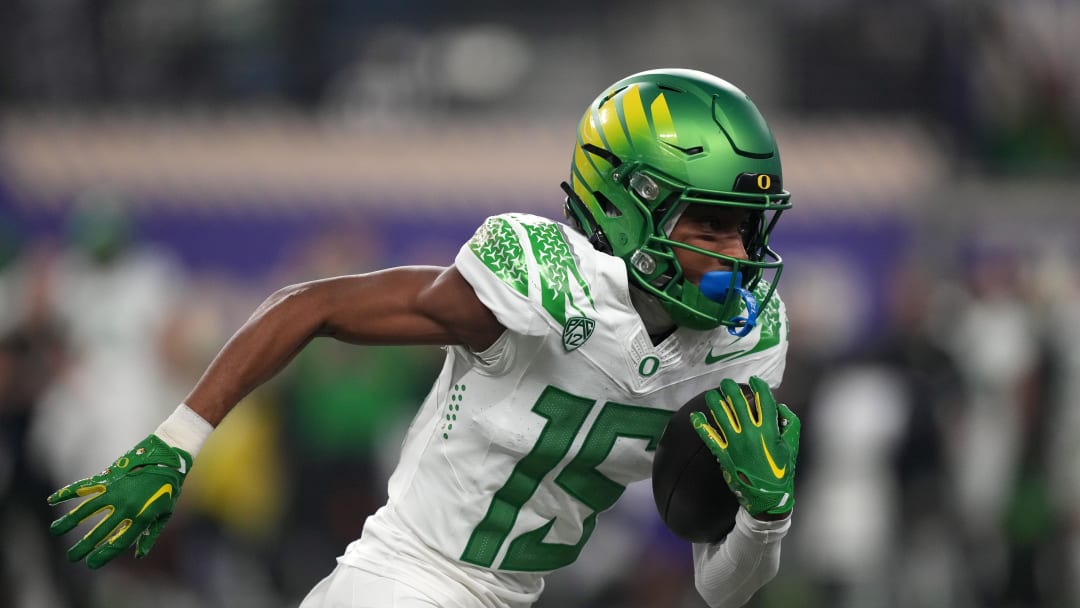 Dec 1, 2023; Las Vegas, NV, USA; Oregon Ducks wide receiver Tez Johnson (15) carries the ball against the Washington Huskies in the first half at Allegiant Stadium. Mandatory Credit: Kirby Lee-USA TODAY Sports