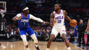 Jan 17, 2023; Los Angeles, California, USA; Philadelphia 76ers guard Shake Milton (18) dribbles the ball against LA Clippers guard Reggie Jackson (1) in the first half at Crypto.com Arena. Mandatory Credit: Kirby Lee-USA TODAY Sports