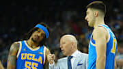 Mar 8, 2025; Los Angeles, California, USA; UCLA Bruins head coach Mick Cronin (center) talks with guard Skyy Clark (55) and guard Lazar Stefanovic (10) in the second half against the Southern California Trojans at Pauley Pavilion presented by Wescom. Mandatory Credit: Kirby Lee-Imagn Images