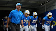 Aug 16, 2025; Inglewood, California, USA; Los Angeles Chargers coach Jim Harbaugh, center Bradley Bozeman (75), guard Jamaree Salyer (68) and guard Zion Johnson (77) enter the field before the game against the Los Angeles Rams at SoFi Stadium. Mandatory Credit: Kirby Lee-Imagn Images