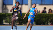 Apr 5, 2025; Gainesville, FL, USA; Tywan Cox of Miami Northwestern (left) defeats Quincy Wilson of Bullis on the anchor of the boys 4 x 400m relay, 3:08.74 to 3:09.97, during the Florida Relays at James G. Pressly Stadium. Mandatory Credit: Kirby Lee-Imagn Images