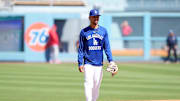 Mar 23, 2025; Los Angeles, California, USA; Los Angeles Dodgers shortstop Mookie Betts warms up before the game against the Los Angeles Angels at Dodger Stadium. Mandatory Credit: Kirby Lee-Imagn Images