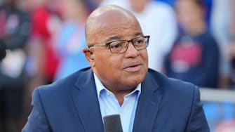 Mike Tirico listens during the 2024 US Olympic track trials in Oregon.