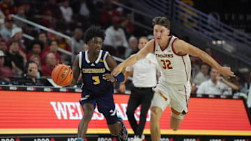 Nov 4, 2024; Los Angeles, California, USA; Chattanooga Mocs guard Honor Huff (3) dribbles the ball against Southern California Trojans guard Clark Slajchert (32) in the second half at Galen Center. Mandatory Credit: Kirby Lee-Imagn Images