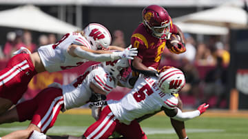 Sep 28, 2024; Los Angeles, California, USA; Southern California Trojans wide receiver Ja'Kobi Lane (8) runs against Wisconsin Badgers linebacker Christian Alliegro (28), safety Hunter Wohler (24) and cornerback RJ Delancy III (5) in the first half at United Airlines Field at Los Angeles Memorial Coliseum. Mandatory Credit: Kirby Lee-Imagn Images