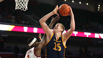 Nov 14, 2023; Los Angeles, California, USA; UC Irvine Anteaters center Bent Leuchten (15) shoots the ball against Southern California Trojans forward Vincent Iwuchukwu (3)  in the first half at Galen Center. Mandatory Credit: Kirby Lee-Imagn Images