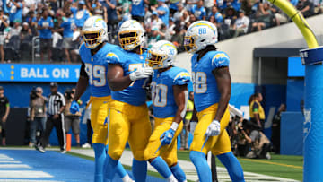 Sep 10, 2023; Inglewood, California, USA; Los Angeles Chargers running back Austin Ekeler (30) celebrates with tight end Donald Parham Jr. (89), guard Zion Johnson (77) and tight end Tre' McKitty (88) after scoring on a 1-yard touchdown run in the first half against the Miami Dolphins at SoFi Stadium. Mandatory Credit: Kirby Lee-Imagn Images