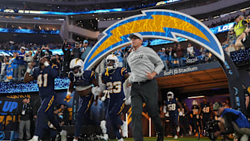 Nov 25, 2024; Inglewood, California, USA; Los Angeles Chargers coach Jim Harbaugh and cornerback Eli Apple (41) and wide receiver Joshua Palmer (5) and safety Tony Jefferson (23) enter the field before the game against the Baltimore Ravens at SoFi Stadium. 