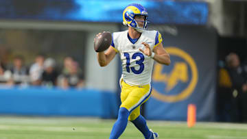 Aug 17, 2024; Inglewood, California, USA; Los Angeles Rams quarterback Stetson Bennett (13) throws the ball against the Los Angeles Chargers in the first half at SoFi Stadium.