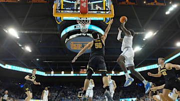 UCLA Bruins Eric Dailey Jr. (3) shoots the ball against Michigan Wolverines center Vladislav Goldin (50)Mandatory Credit: Kirby Lee-Imagn Images