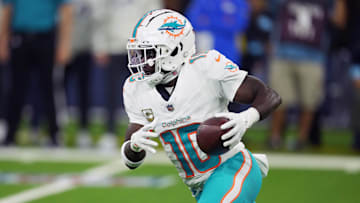 Nov 11, 2024; Inglewood, California, USA; Miami Dolphins wide receiver Tyreek Hill (10) carries the ball against the Los Angeles Rams in the second half at SoFi Stadium. Mandatory Credit: Kirby Lee-Imagn Images