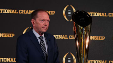 Jan 9, 2024; Houston, TX, USA; College Football Playoff senior director of communications Brett Daniels poses with CFP National Championship trophy at press conference at JW Marriot Houston by the Galleria. Mandatory Credit: Kirby Lee-Imagn Images