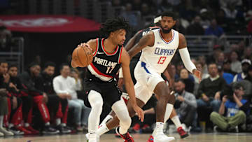 Dec 11, 2023; Los Angeles, California, USA;Portland Trail Blazers guard Shaedon Sharpe (17) dribbles against LA Clippers forward Paul George (13) in the first half at Crypto.com Arena. Mandatory Credit: Kirby Lee-USA TODAY Sports