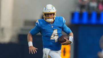 Aug 16, 2025; Inglewood, California, USA; Los Angeles Chargers quarterback Taylor Heinicke (4) carries the ball against the Los Angeles Rams in the first half at SoFi Stadium. Mandatory Credit: Kirby Lee-Imagn Images