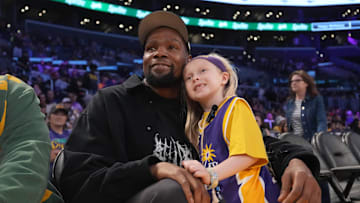 May 23, 2025; Los Angeles, California, USA; Kevin Durant poses with 8-year-old LA Sparks fan Vivian Havens during the game against the Golden State Valkyries at Crypto.com Arena. Mandatory Credit: Kirby Lee-Imagn Images