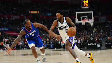 Dec 6, 2023; Los Angeles, California, USA; Sacramento Kings guard Malik Monk (0) dribbles the ball against LA Clippers forward Kawhi Leonard (2) in the second half at Crypto.com Arena. Mandatory Credit: Kirby Lee-Imagn Images