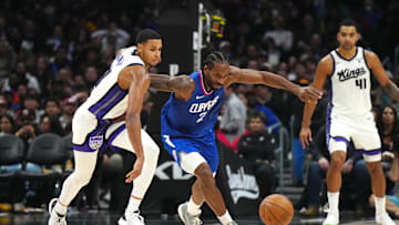Dec 6, 2023; Los Angeles, California, USA; Sacramento Kings forward Keegan Murray (13) and LA Clippers forward Kawhi Leonard (2) reach for the ball in the second half at Crypto.com Arena. Mandatory Credit: Kirby Lee-Imagn Images