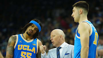 Mar 8, 2025; Los Angeles, California, USA; UCLA Bruins head coach Mick Cronin (center) talks with guard Skyy Clark (55) and guard Lazar Stefanovic (10) in the second half against the Southern California Trojans at Pauley Pavilion presented by Wescom. Mandatory Credit: Kirby Lee-Imagn Images