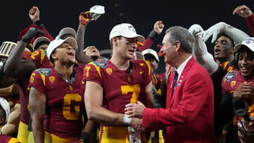 Dec 27, 2023; San Diego, CA, USA; Southern California Trojans quarterback Miller Moss (7) shakes hands with DirecTV Holiday Bowl president Dennis Dubard after victory over the Louisville Cardinals at Petco Park. Mandatory Credit: Kirby Lee-USA TODAY Sports