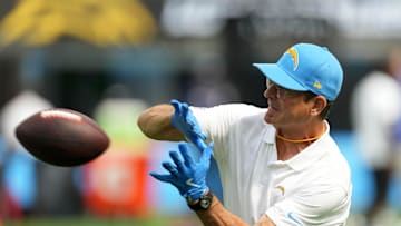 Aug 17, 2024; Inglewood, California, USA; Los Angeles Chargers coach Jim Harbaugh catches the ball during the game against th eLos Angeles Rams in the first half at SoFi Stadium. Mandatory Credit: Kirby Lee-Imagn Images