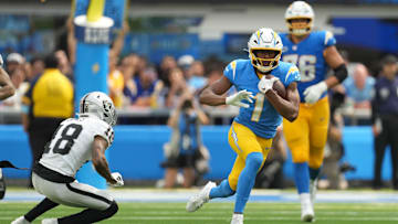 Sep 8, 2024; Inglewood, California, USA; Los Angeles Chargers wide receiver Quentin Johnston (1) carries the ball against Las Vegas Raiders cornerback Jack Jones (18) in the second half at SoFi Stadium. Mandatory Credit: Kirby Lee-Imagn Images