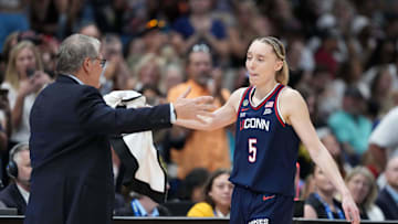 Apr 6, 2025; Tampa, FL, USA; UConn Huskies coach Geno Auriemma (left) and guard Paige Bueckers (right) embrace in the fourth quarter during the national championship of the women's 2025 NCAA tournament against the South Carolina Gamecocks at Amalie Arena. Mandatory Credit: Kirby Lee-Imagn Images
