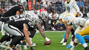 Dec 4, 2022; Paradise, Nevada, USA; Helmets at the line of scrimmage as Las Vegas Raiders center