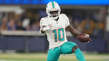 Nov 11, 2024; Inglewood, California, USA; Miami Dolphins wide receiver Tyreek Hill (10) carries the ball against the Los Angeles Rams in the first half at SoFi Stadium.