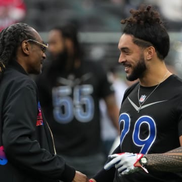 Feb 5, 2023; Paradise, Nevada, USA; AFC captain Snoop Dogg (left) shakes hands with NFC safety Talanoa Hufanga of the San Francisco 49ers (29) during the Pro Bowl Games at Allegiant Stadium. Mandatory Credit: Kirby Lee-USA TODAY Sports