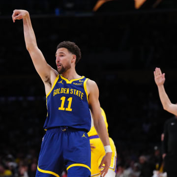 Apr 9, 2024; Los Angeles, California, USA; Golden State Warriors guard Klay Thompson (11) follows through on a three-point shot against the Los Angeles Lakers in the second half at Crypto.com Arena. Mandatory Credit: Kirby Lee-USA TODAY Sports