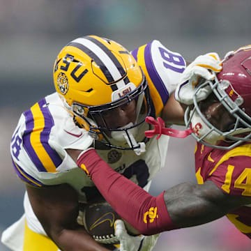 Sep 1, 2024; Paradise, Nevada, USA; LSU Tigers running back Josh Williams (18) carries the ball against Southern California Trojans cornerback Jacobe Covington (14) in the first half at Allegiant Stadium. Mandatory Credit: Kirby Lee-Imagn Images