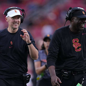 Sep 2, 2023; Los Angeles, California, USA; Southern California Trojans head coach Lincoln Riley (leff) and wide receivers coach Dennis Simmons react against the Nevada Wolf Pack in the second half at United Airlines Field at Los Angeles Memorial Coliseum. Mandatory Credit: Kirby Lee-Imagn Images