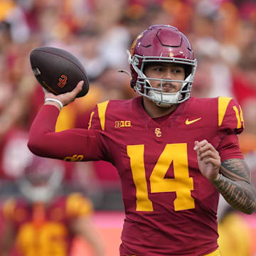 Nov 30, 2024; Los Angeles, California, USA; Southern California Trojans quarterback Jayden Maiava (14) throws the ball against the Notre Dame Fighting Irish in the first half at United Airlines Field at Los Angeles Memorial Coliseum. Mandatory Credit: Kirby Lee-Imagn Images
