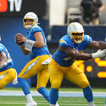 Sep 8, 2024; Inglewood, California, USA; Los Angeles Chargers quarterback Justin Herbert (10) throws the ball against the Las Vegas Raiders in the first half at SoFi Stadium. Mandatory Credit: Kirby Lee-Imagn Images