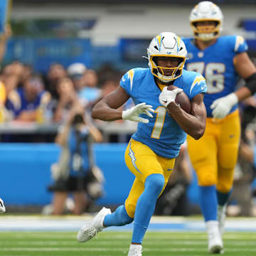 Sep 8, 2024; Inglewood, California, USA; Los Angeles Chargers wide receiver Quentin Johnston (1) carries the ball against Las Vegas Raiders cornerback Jack Jones (18) in the second half at SoFi Stadium. Mandatory Credit: Kirby Lee-Imagn Images