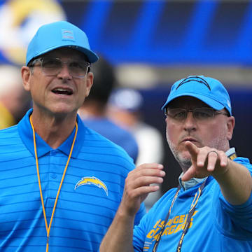 Aug 16, 2025; Inglewood, California, USA; Los Angeles Chargers coach Jim Harbaugh (left) and general manager Joe Hortiz react during the game against the Los Angeles Rams at SoFi Stadium. Mandatory Credit: Kirby Lee-Imagn Images