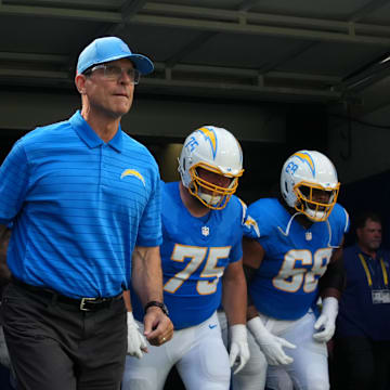 Aug 16, 2025; Inglewood, California, USA; Los Angeles Chargers coach Jim Harbaugh, center Bradley Bozeman (75), guard Jamaree Salyer (68) and guard Zion Johnson (77) enter the field before the game against the Los Angeles Rams at SoFi Stadium. Mandatory Credit: Kirby Lee-Imagn Images