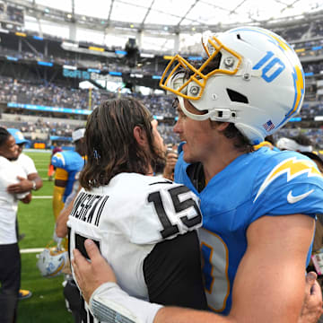 Sep 8, 2024; Inglewood, California, USA; Las Vegas Raiders quarterback Gardner Minshew (15) and Los Angeles Chargers quarterback Justin Herbert (10) embrace after the game at SoFi Stadium. Mandatory Credit: Kirby Lee-Imagn Images