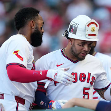 Angels third baseman Yoan Moncada (5) is congratulated by center fielder Jo Adell (7) after hitting a two-run home run in the first inning against the Arizona Diamondbacks at Angel Stadium on July 11.