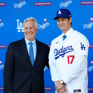 Dec 14, 2023; Los Angeles, CA, USA; Los Angeles Dodgers designated hitter Shohei Ohtani (17) poses with owner Mark Walter at press conference at Dodger Stadium. Mandatory Credit: Kirby Lee-Imagn Images